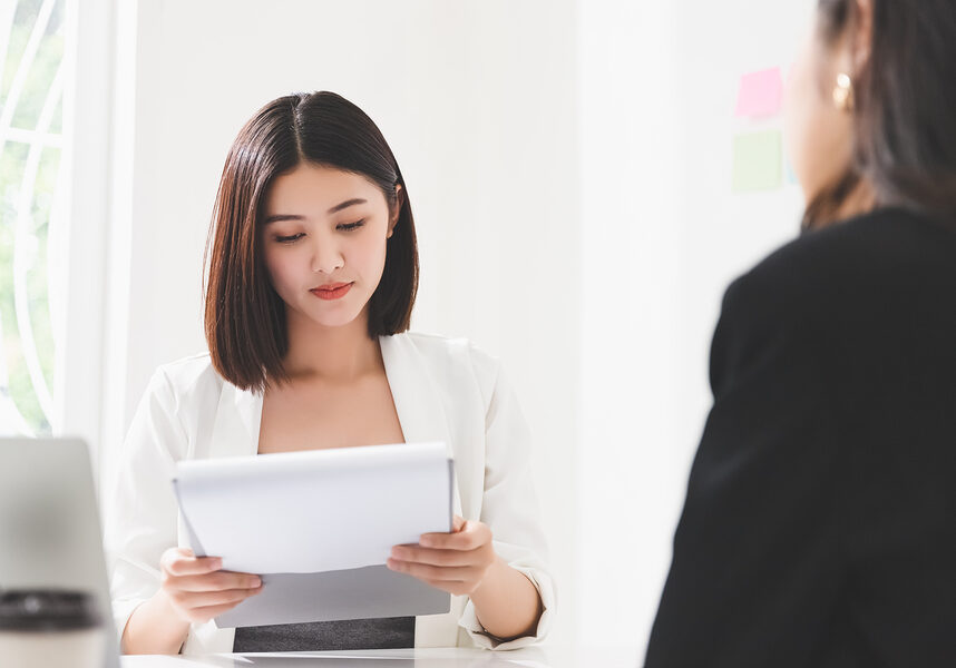 young attractive asian woman is interviewing for a job.