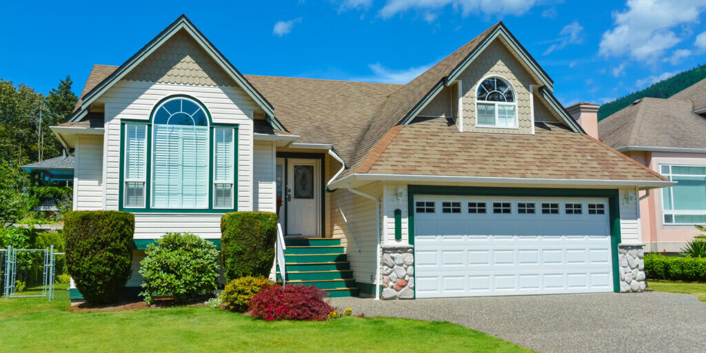 house with a lawn on the sides of the garage