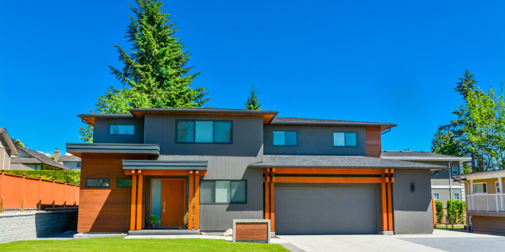 a modern type house with lawn and concrete driveway